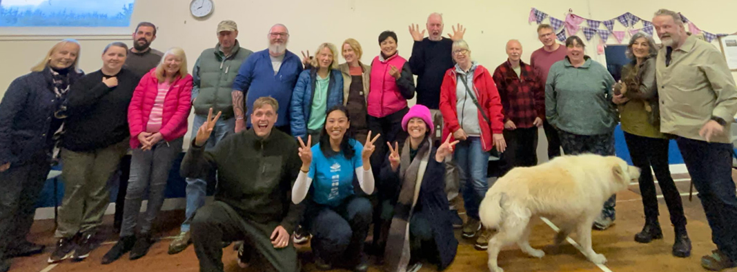 Group of smiling people in the village hall