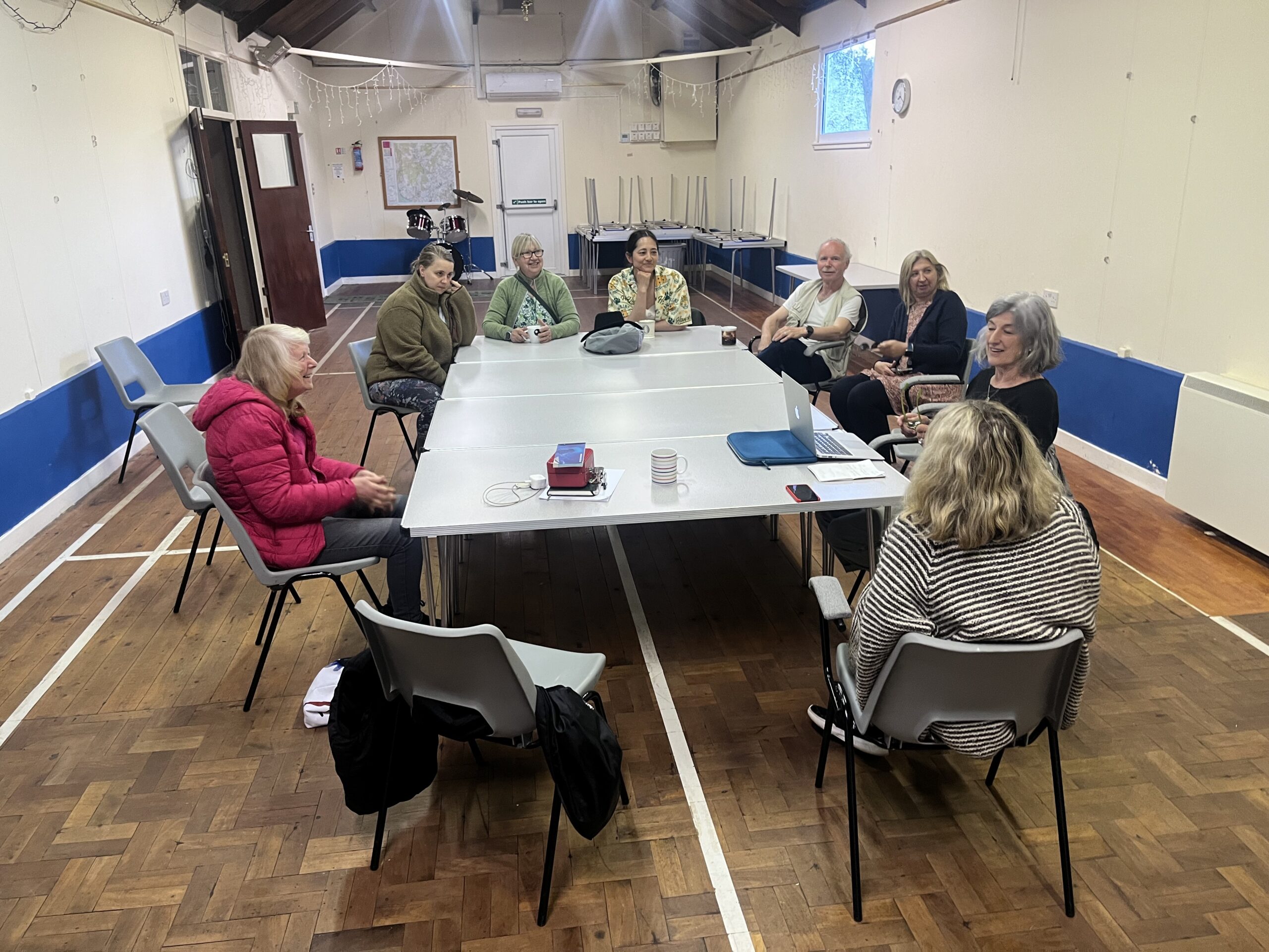 Committee members sitting round a table at Mossdale Village Hall